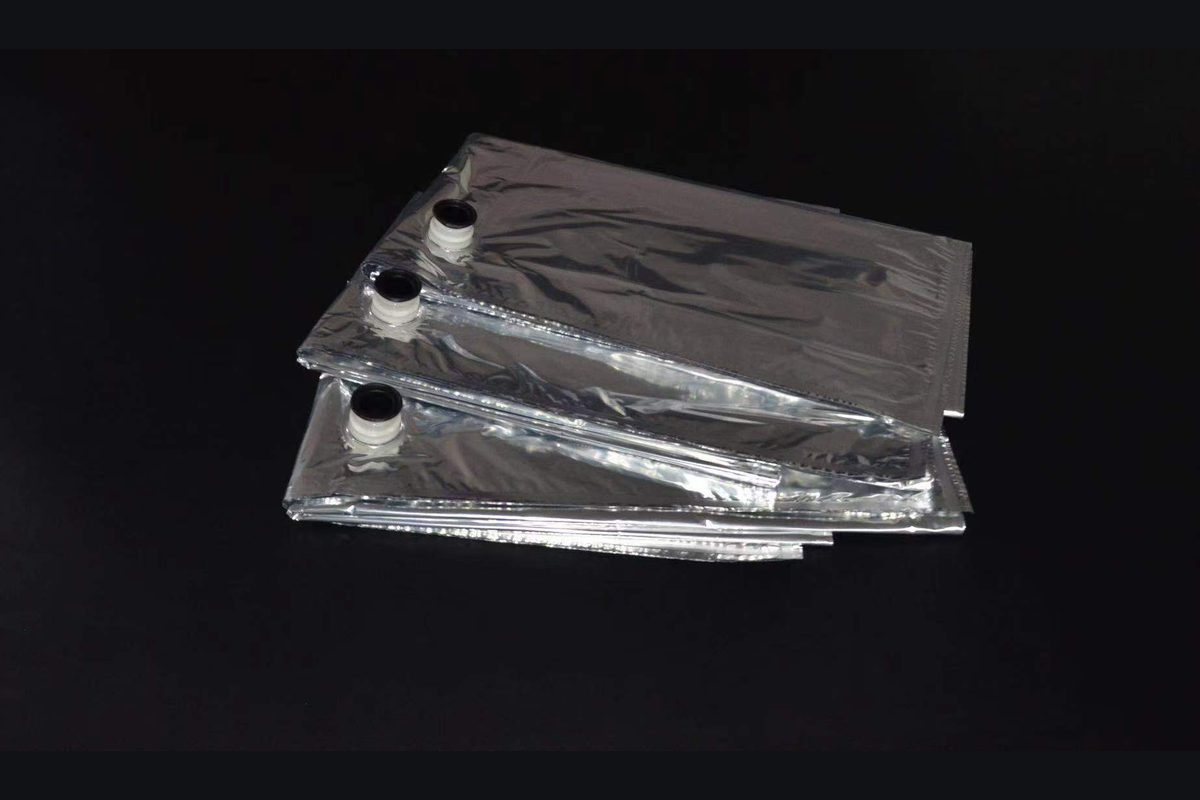 Folded metallized flexible bags with filling spouts