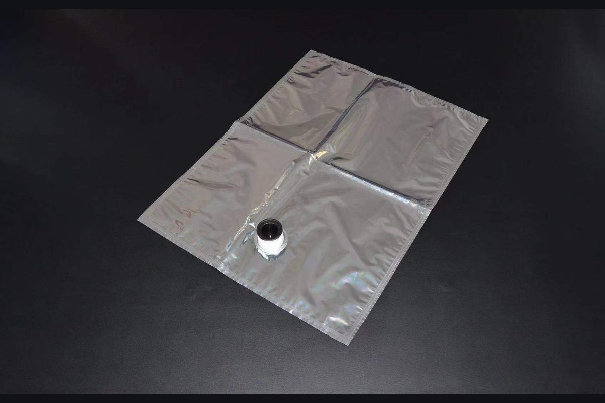 Metallized flexible aseptic bag laid flat with its filling spout visible
